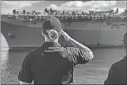  ?? COURTESY OF CECELIA HOSLEY ?? While stationed on the Coast Guard cutter Walnut and working aids to navigation at the entrance to Pearl Harbor, Lt. j.g. Cecelia Hosley salutes a passing Navy vessel returning to Pearl Harbor on Nov. 13, 2019, after a deployment.