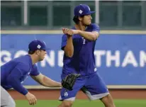  ?? Associated Press ?? Los Angeles Dodgers' Yu Darvish, right, takes a batting stance during a practice for a World Series baseball game Thursday in Houston. Darvish will face the Houston Astros in Game 3 today.