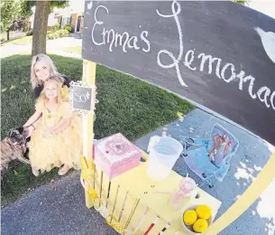  ?? RON PIETRONIRO/METROLAND ?? Shannin Wilson with her daughter, Emma, and their dog, Copper, who suffered a broken back in a late-May accident. Emma has been running a lemonade stand to raise money for a wheelchair.