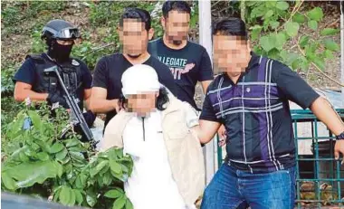  ?? PIC COURTESY OF THE POLICE ?? The Indonesian worker being detained by counterter­rorism operatives in Kuala Lumpur recently.