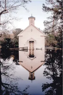  ??  ?? “A church flooded by Hurricane Florence stands silently in its reflection in Burgaw, North Carolina, 2018,” by Ryan Vizzions.