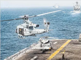  ?? LANCE CPL. DALTON SWANBECK/U.S. NYT ?? In a photo from the U.S. Marine Corps, a helicopter takes off from the flight deck of the Boxer, an amphibious assault ship, in the Strait of Hormuz, on Thursday.