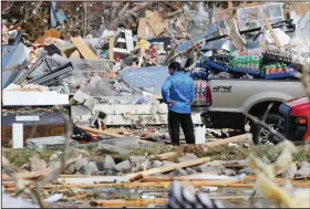  ?? (AP/Mark Humphrey) ?? A man looks for items he can salvage from his store Tuesday near Cookeville, Tenn.