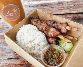  ?? Mike Sutter / Staff ?? Moo ping, or grilled pork skewers, are served with rice and Thai chile sauce, and milky-sweet Thai tea comes in a sealed bag — kind of like a juice pouch.