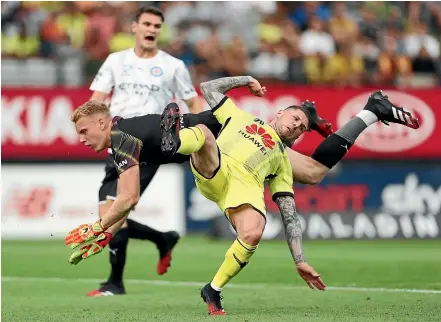  ?? GETTY IMAGES ?? Melbourne City Tom Glover was collected by Wellington Phoenix striker Gary Hooper, right, during a first-half challenge in the A-League match at Eden Park in Auckland last night.