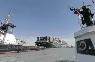  ?? Suez Canal Authority / AFP via Getty Images ?? A tugboat pulls the Ever Given after it was dislodged from a bank of the Suez Canal in Egypt. The container ship had crashed last week in a single-lane stretch of the canal.