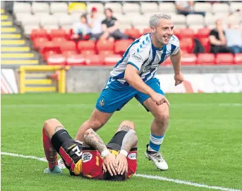  ??  ?? Scott Robinson wheels away in delight after Kevin Holt’s own goal put Killie ahead