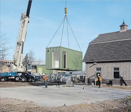  ?? DAVE JOHNSON THE WELLAND TRIBUNE ?? A shipping container that will form part of a facility to house Niagara College's commercial cannabis production program is moved into place at the Niagara-on-the-Lake campus Friday.