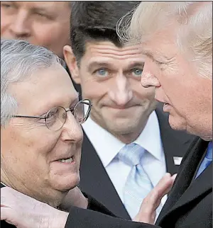  ?? AP/MANUEL BALCE CENETA ?? President Donald Trump on Wednesday at the White House congratula­tes Senate Majority Leader Mitch McConnell and House Speaker Paul Ryan (center) on passage of the tax-overhaul bill.