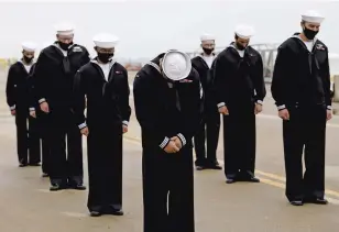  ?? JONATHON GRUENKE/STAFF ?? Sailors of the USS Cole bow their heads during a benedictio­n following a remembranc­e ceremony commemorat­ing the 20th anniversar­y of the attack on USS Cole Monday morning.