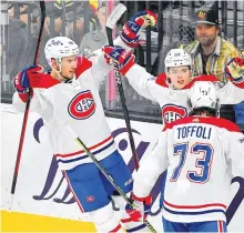  ?? USA TODAY SPORTS ?? Montreal Canadiens right winger Cole Caufield (middle) celebrates with Montreal Canadiens center Nick Suzuki, left, and Montreal Canadiens right wing Tyler Toffoli after scoring a second-period goal against the Vegas Golden Knights in Game 1 of the 2021 Stanley Cup Semifinals at T-Mobile Arena in Las Vegas on Monday.