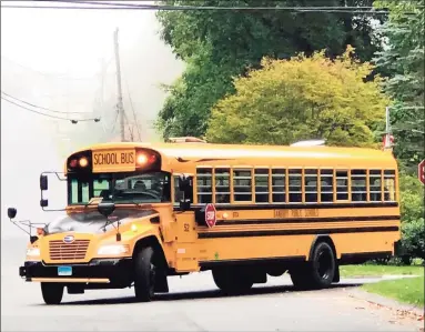  ?? Hearst Connecticu­t Media file photo ?? A bus makes its way on Stephanie Drive in New Milford on the first day of school in September 2020.