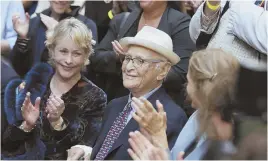  ?? STAFF PHOTOS BY NICOLAUS CZARNECKI ?? Television legend Norman Lear, applauded above, was honored with a statue, below, at Emerson College yesterday.