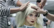  ?? PAULA BRONSTEIN/GETTY IMAGES ?? A model has her wig styled backstage during a fashion show. Sony says its ‘SmartWig’ would contain a sensor, a processor unit and a communicat­ion interface, all hidden from view.