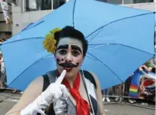  ??  ?? Umbrellas came in handy, especially at the start of Sunday’s Pride parade.