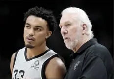  ?? AP photo ?? San Antonio Spurs coach Gregg Popovich confers with guard Tre Jones during the second half of the team's NBA basketball game against the Denver Nuggets on Friday in Denver.