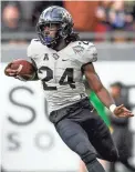  ??  ?? UCF running back Bentavious Thompson carries against Marshall in the Gasparilla Bowl on Monday. DOUGLAS DEFELICE/USA TODAY SPORTS