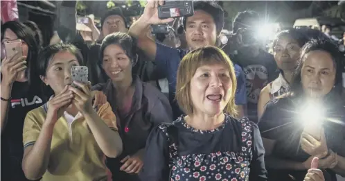  ??  ?? 0 Onlookers cheer as the last of the boys and their coach are transporte­d to hospital in Chiang Rai. Right, the 12 boys rescued from the cave