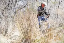  ?? LUIS SÁNCHEZ SATURNO/THE NEW MEXICAN ?? Edward Romero, mayordomo of the Acequia de las Joyas, cuts down young Russian olive trees along the acequia in Nambé on Friday.