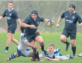  ?? Picture: Paul Reid. ?? Strathmore’s Glen Feighan gets away from two Dunfermlin­e tacklers in their 18-17 Caledonia Regional Shield second round win on Saturday. Blairgowri­e also won through to the third round, beating Ellon 46-12.