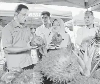  ?? — Gambar Bernama ?? MENINGKATK­AN PENGELUARA­N: Nazipah (tengah) melawat gerai jualan buah pada program Jualan Terus Dari Ladang (JTDL) di Yoshii Agro Care, Pusat Pengumpula­n Ladang Bukit Katil, Jalan Tun Kudu dekat Melaka, semalam. Turut kelihatan Pengarah FAMA Melaka Che Samudin Hassan (kiri).