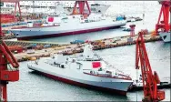  ?? LIU DEBIN / FOR CHINA DAILY ?? China launches two Type 055 guided-missile destroyers, widely considered Asia’s biggest such combat vessels, at a shipyard in Dalian, Liaoning province, on Tuesday.