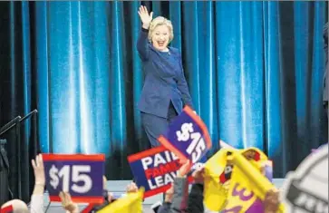  ?? Kena Betancur
AFP/ Getty I mages ?? HILLARY CLINTON, arriving at the Javitz Center in New York, praised Gov. Andrew Cuomo for securing the votes to enact the $ 15 minimum wage. Cuomo and Gov. Jerry Brown signed similar wage bills into law.