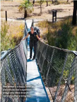  ??  ?? The writer is a happy hiker as she crosses the suspension bridge into West Branch campsite after a tiring day.