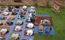  ?? Dar Yasin / Associated Press ?? Kashmiri Muslims offer Eid prayers on Sunday in Srinagar, India. Eid al-Fitr is the end of the fasting month of Ramadan.