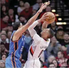  ??  ?? PORTLAND: Portland Trail Blazers guard Damian Lillard (right) shoots over Oklahoma City Thunder forward Andre Roberson during the first half of an NBA basketball game on Thursday, March 2, 2017. — AP