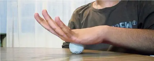  ??  ?? Golf ball roll: Once you’re done with the rubber band, you can add on this tension-releasing exercise using a golf ball. Place the golf ball on a flat surface and put your palm over it. Using a circular motion, roll the ball from the bottom of the palm to the top, sides, fingers and back around, making sure you hit every point. If it’s too easy, apply a bit more pressure and pause a little longer at the tender spots. After rolling the perimeter, massage the centre with small circles, clockwise and anti-clockwise. Repeat five times.