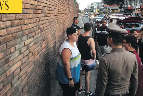  ?? CHIANG MAI NEWS VIA AP ?? Albertan Brittney Schneider, left, and Briton Furlong Lee, second from left, stand in front of Tha Pae Gate in Chiang Mai province, northern Bangkok.