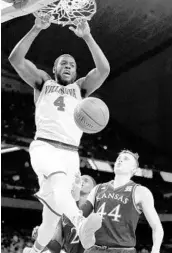  ?? DAVID J. PHILLIP/ASSOCIATED PRESS ?? Villanova's Eric Paschall (4) dunks over Kansas's Mitch Lightfoot (44) during the second half on Saturday night.