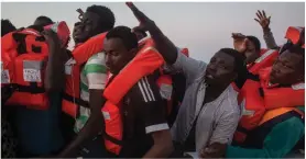  ??  ?? Rescue: Stranded African migrants trying to reach Italy in June