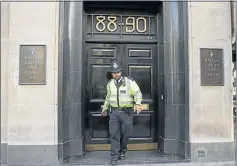  ?? Picture: REUTERS ?? A police officer leaves a safe deposit building on Hatton Garden, central London, in April. A gang, with two members in their mid-seventies, is accused of stealing a £10m haul of cash and gems.