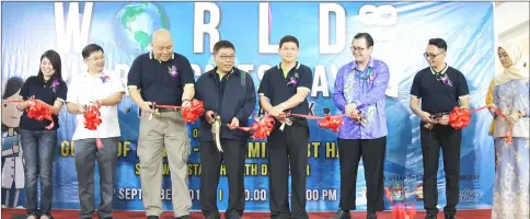  ??  ?? Abu Hassan (fourth left) with other guests cutting a ribbon to symbolical­ly launch World Pharmacist­s Day.