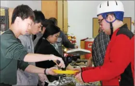  ?? KRISTI GARABRANDT — THE NEWS-HERALD ?? Seniors from Lake Catholic High School serve a Thanksgivi­ng lunch to clients at Lake County Board of DD/Deepwood Willoughby Branch on Nov. 20.