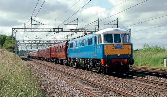  ?? Stuart J Hood ?? AC electric No. 86259 Les Ross/Peter Pan (formerly E3137) in electric blue races past Chorlton with a 1Z86 07.10 London Euston to Carlisle ‘Cumbrian Mountain Express' charter on June 26.
