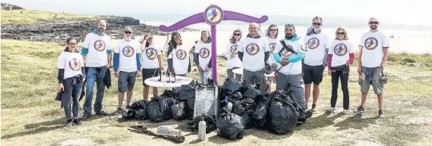  ??  ?? Seventy two volunteers cleared 220kg of litter off Porthcawl Beach on Sunday as part of the Barefoot Wine Beach Rescue Project