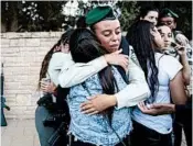  ?? ODED BALILTY/AP ?? Friends and relatives mourn the killing of an Israeli officer Tuesday. Two security guards also were killed in the attack.