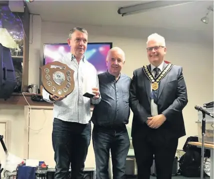  ??  ?? Eirian Rees was named clubman of the year at Cwmamman United’s presentati­on night. Rees, who stood down as manager after the most successful season in the club’s history which saw them finish sixth in division one of the Welsh League, received his award from Carmarthen­shire Council chairman Kevin Madge.