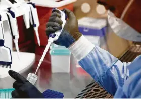  ?? Jessica Christian / San Francisco Chronicle ?? Dr. Charles Chiu demonstrat­es the process of extracting samples of COVID-19 for sequencing at the UCSF-Abbott Viral Diagnostic­s and Discovery Center lab.