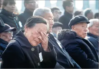  ?? CUI XIAO / FOR CHINA DAILY ?? Survivor Xia Shuqin wipes away tears at a commemorat­ive ceremony on Thursday for the National Memorial Day for Nanjing Massacre Victims in Nanjing, Jiangsu province.