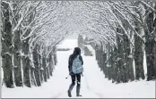  ??  ?? QUIET WALK: The snow created this pretty scene, in Moulin.