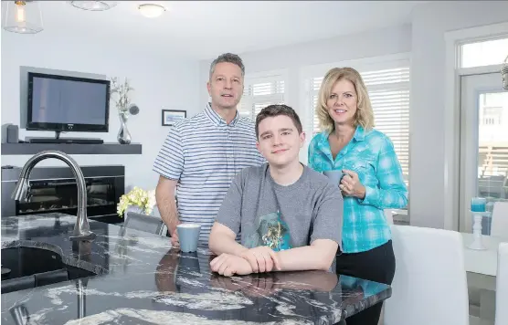  ?? DON MOLYNEAUX ?? Andy and Trish Meier, and their son Aedan, are settling in to their new two-storey, three-bedroom home in Nolan Hill that they were able to customize before it was built.