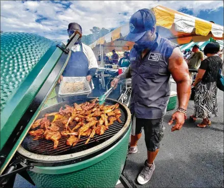  ?? COURTESY OF CHEF DAVID ROSE ?? David Rose, a Big Green Egg Ambassador, grills at an event. Rose says the values of family, good food and hard work were passed down from his father. Raised in New Jersey by Jamaican parents who were chefs, Rose now works as a private chef and caterer.