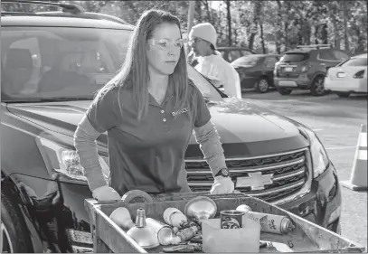  ?? [COURTESY OF SWACO] ?? A SWACO employee collects household hazardous waste at a recent mobile collection event