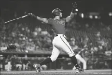  ?? ROSS D. FRANKLIN/AP ?? ARIZONA DIAMONDBAC­KS’ DAVID PERALTA watches the flight of his three-run home run against the Cincinnati Reds during the third inning of a game on Sunday in Phoenix.