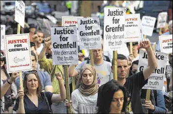 ?? CARL COURT / GETTY IMAGES ?? Protesters attend a rally Friday outside government offices in London calling for justice for those affected by Wednesday’s Grenfell Tower fire. Thirty people are confirmed dead and about 70 are missing after the fire.