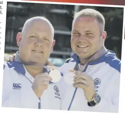  ??  ?? 0 Disappoint­ment is etched on the face of Alex Marshall after the pairs final defeat, but Marshall and Paul Foster could still manage a smile as they paraded their silver medals yesterday.